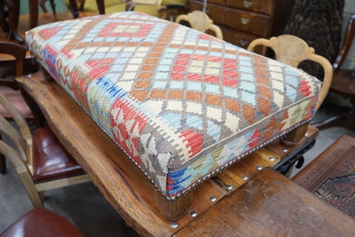 A rectangular Kelim footstool on oak feet, length 114cm, depth 60cm, height 30cm